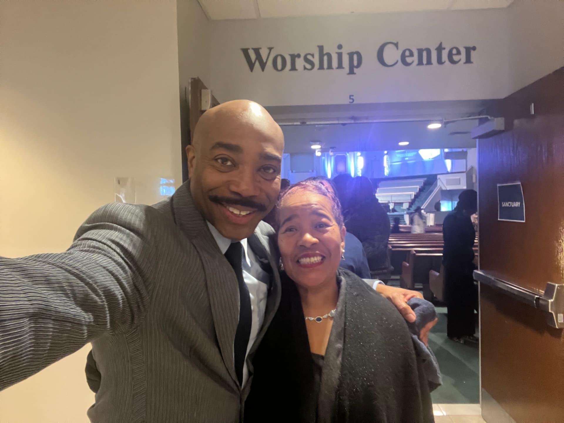 Dr. Orr taking a selfie with a church member at the sanctuary doors